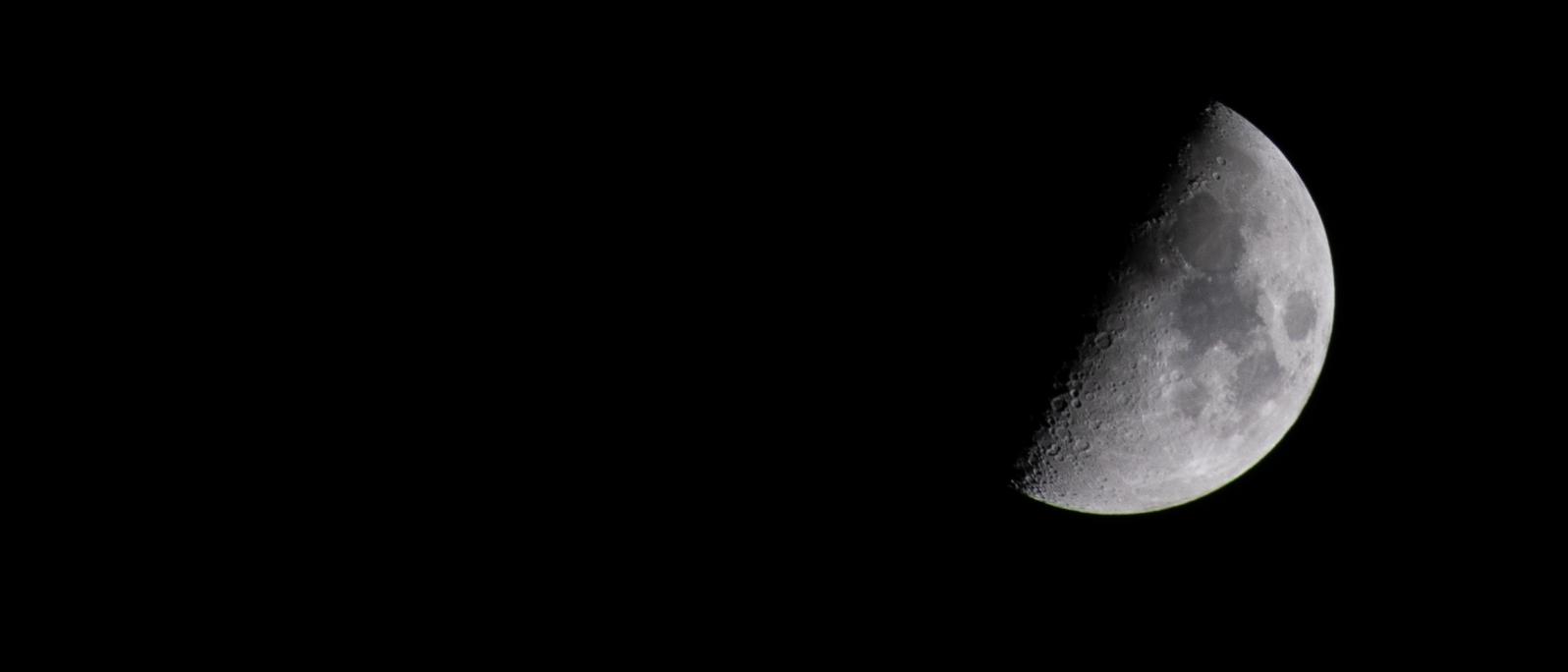 Half-lit moon on a jet-black night